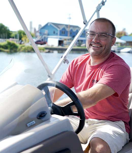 Bill Hosmer on a boat at Hosmer’s Marina